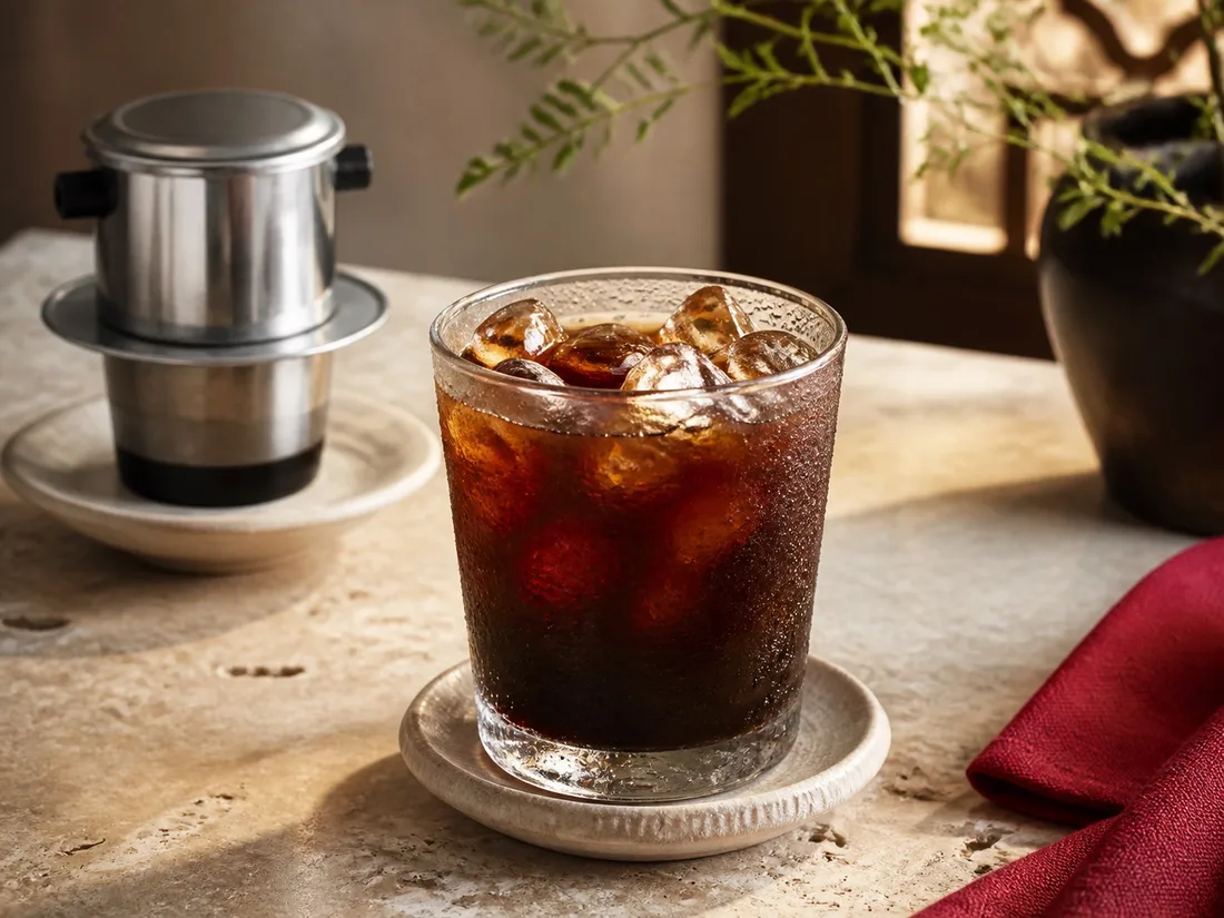 Strong iced black coffee from a metal phin filter